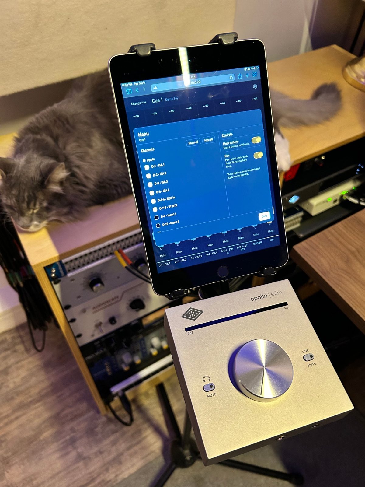 YourCue's menu open on an iPad on a mic stand, with an Apollo e2m beside it.